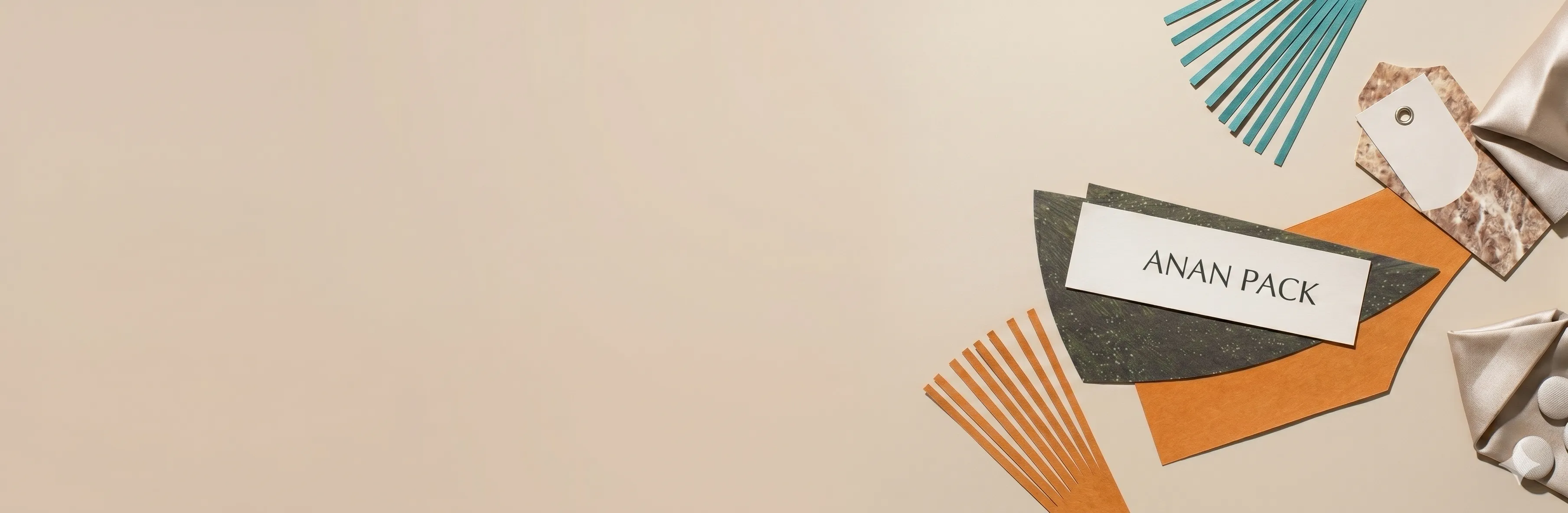 Cosmetics and beauty packaging materials arranged on textured paper