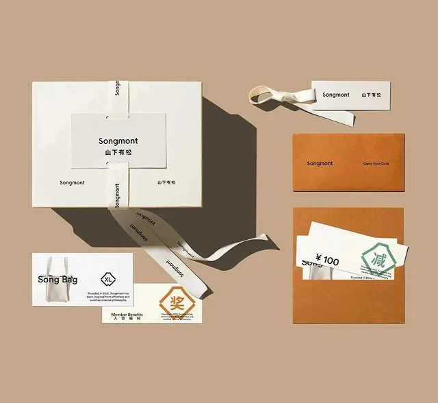 Folded home textile packaging set with branded ribbons and zipper pouch